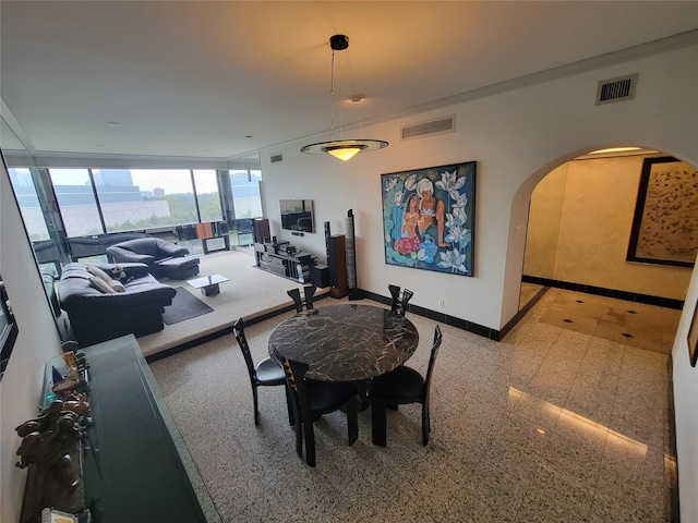 dining room featuring expansive windows and ornamental molding