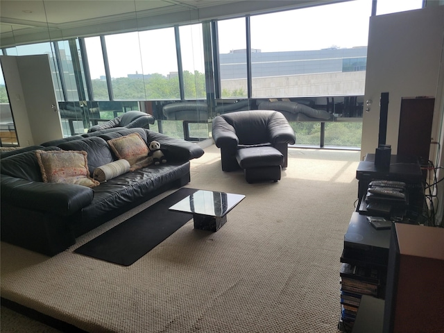 living room featuring floor to ceiling windows, carpet flooring, and a water view