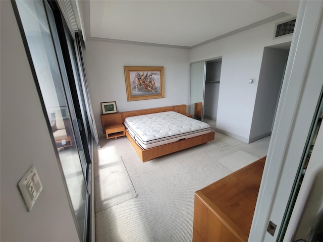 bedroom featuring light colored carpet, a closet, and crown molding