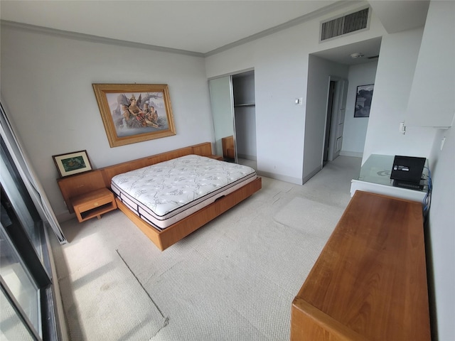 carpeted bedroom featuring a closet and crown molding