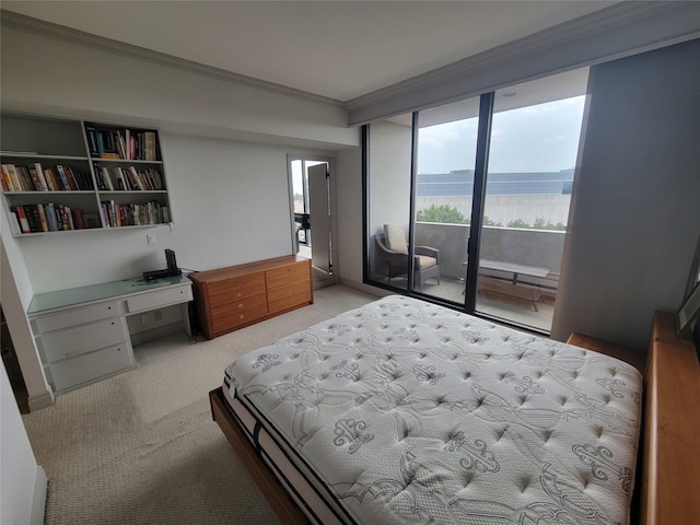 bedroom featuring access to outside, built in desk, ornamental molding, and a water view