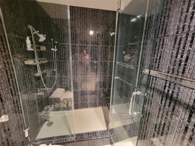 bathroom with a shower with door