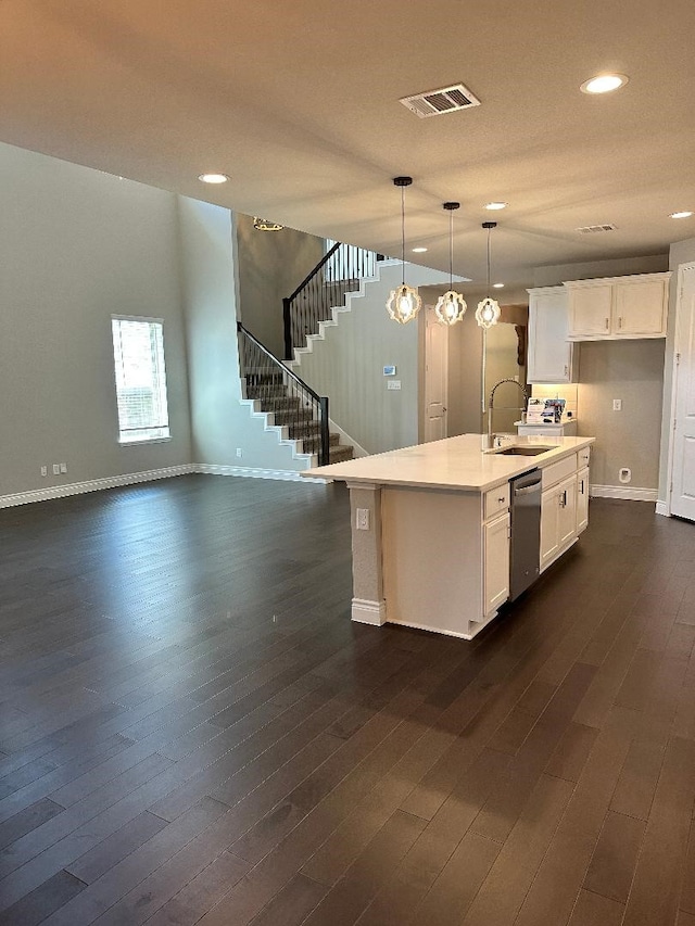 kitchen with a sink, dark wood-type flooring, dishwasher, and white cabinets