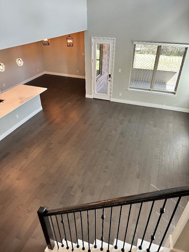 interior space featuring a chandelier, baseboards, and wood finished floors