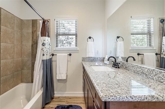 bathroom with vanity, hardwood / wood-style flooring, plenty of natural light, and shower / tub combo with curtain