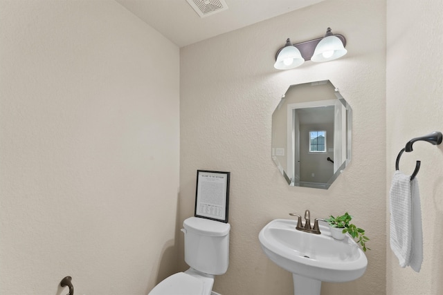 bathroom featuring sink and toilet