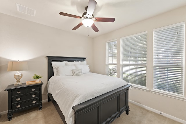 bedroom with light colored carpet and ceiling fan