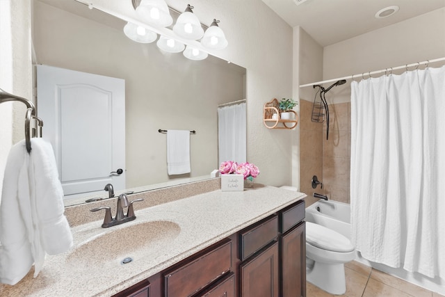 full bathroom with tile patterned floors, vanity, shower / bath combo with shower curtain, and toilet