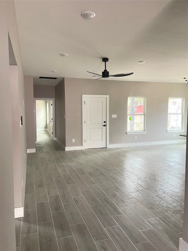 empty room with ceiling fan and dark hardwood / wood-style flooring