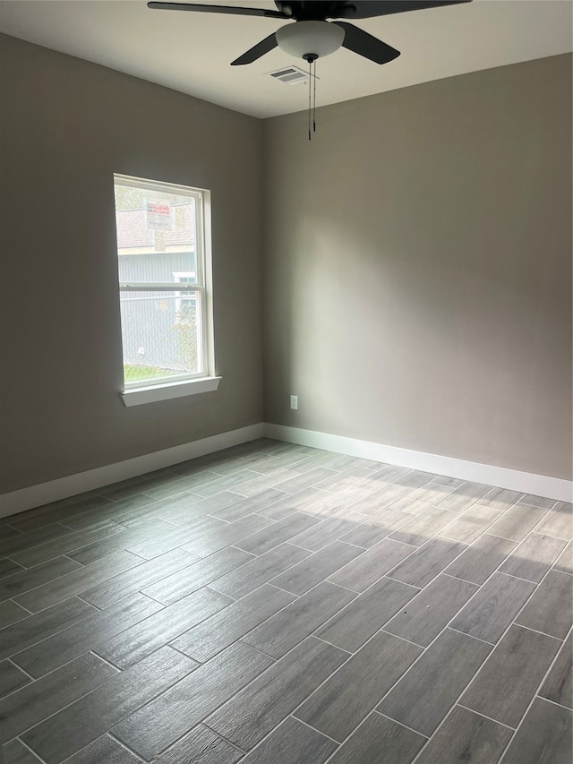 spare room with ceiling fan and dark hardwood / wood-style flooring