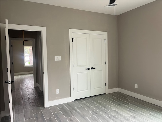 unfurnished bedroom featuring light hardwood / wood-style floors and a closet