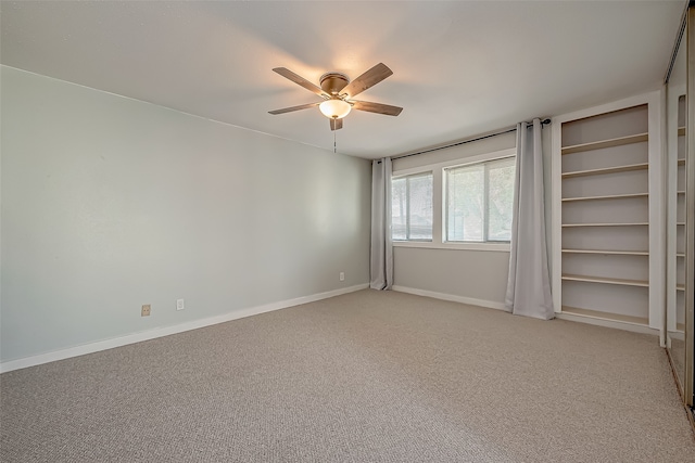 spare room with light carpet and ceiling fan