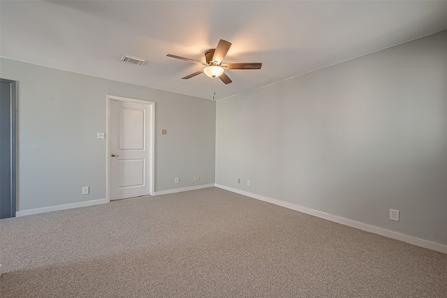 carpeted spare room featuring ceiling fan