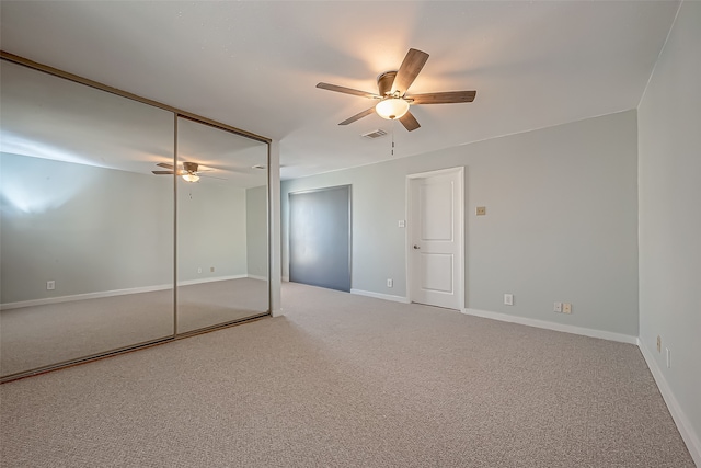 unfurnished bedroom with a closet, carpet floors, and ceiling fan