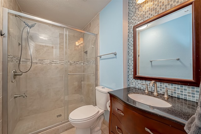 bathroom with tasteful backsplash, a shower with door, tile walls, toilet, and vanity