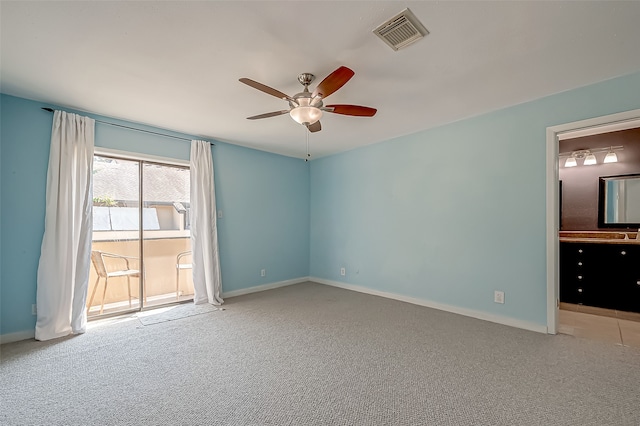 carpeted empty room featuring ceiling fan