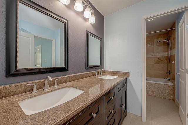 bathroom featuring vanity, tiled shower / bath, and tile patterned flooring