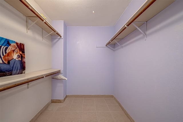 spacious closet featuring light tile patterned floors