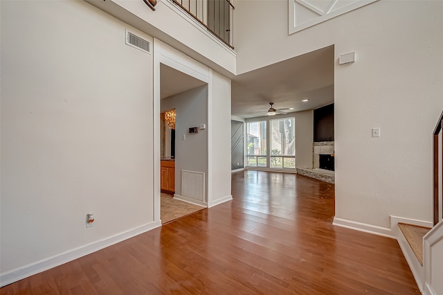 unfurnished living room with wood-type flooring and ceiling fan