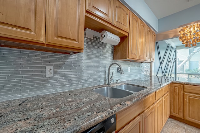 kitchen featuring sink, an inviting chandelier, light tile patterned floors, light stone counters, and tasteful backsplash