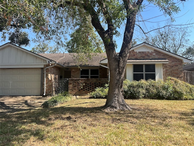 single story home featuring a garage and a front lawn