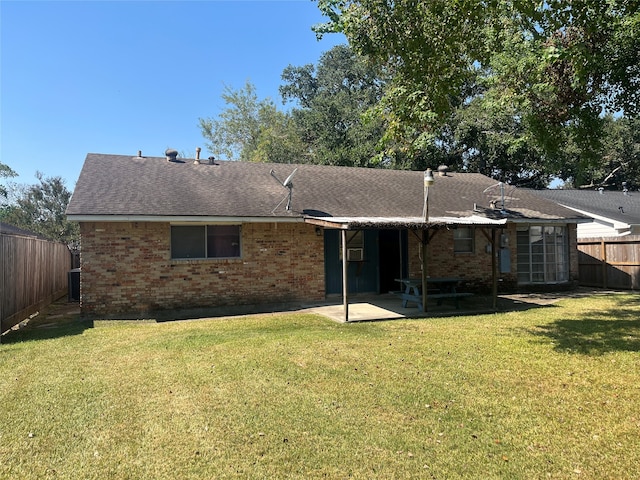 rear view of house featuring a patio, a yard, and cooling unit