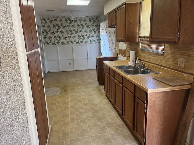 kitchen featuring sink and a textured ceiling