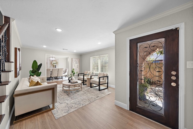 entryway featuring light wood-type flooring and crown molding