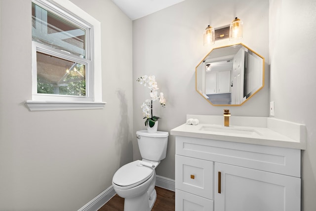 bathroom featuring hardwood / wood-style floors, vanity, and toilet