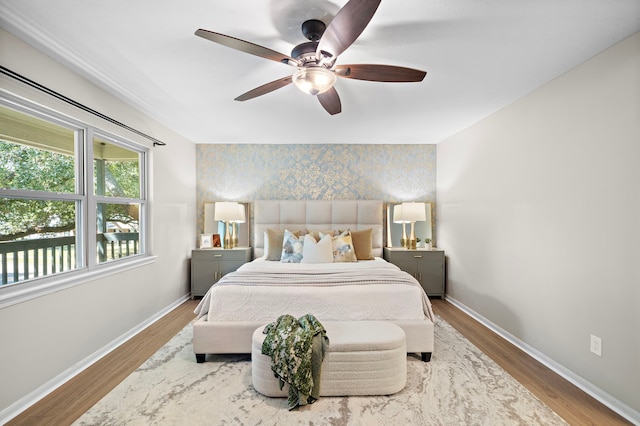 bedroom with ceiling fan and wood-type flooring