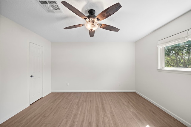 spare room featuring ceiling fan and light hardwood / wood-style flooring