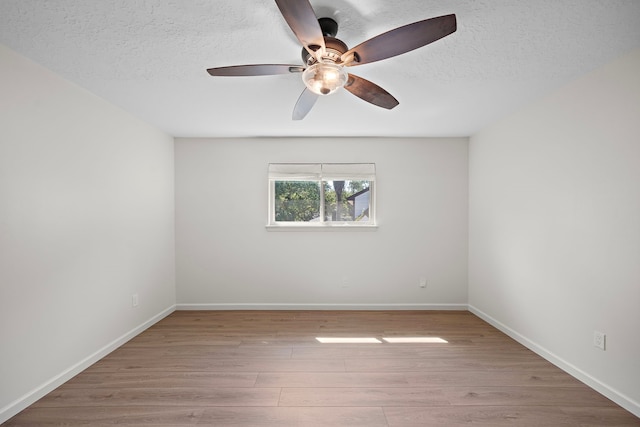 unfurnished room with light wood-type flooring, ceiling fan, and a textured ceiling