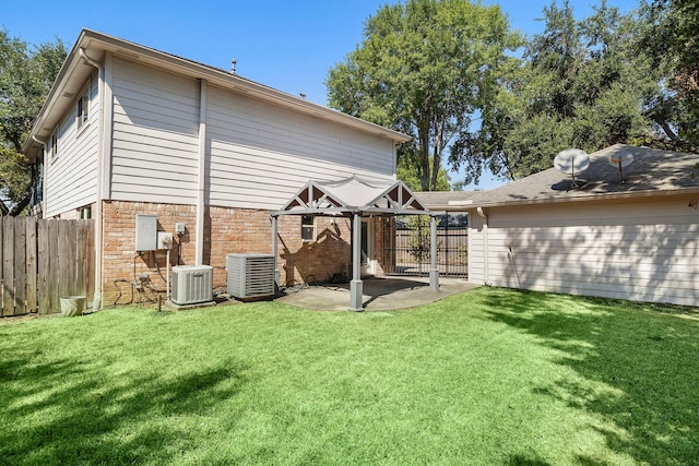 back of house featuring central air condition unit, a patio, and a yard