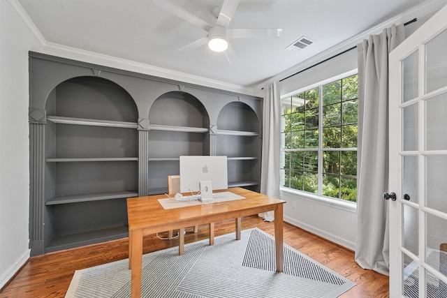 home office with ornamental molding, hardwood / wood-style floors, ceiling fan, and built in shelves