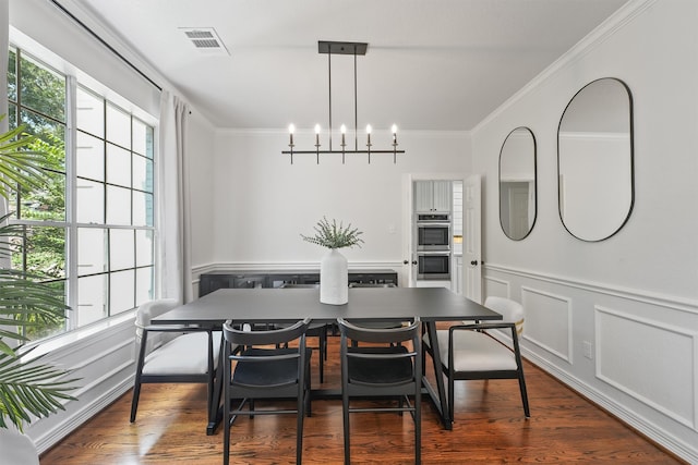 dining area featuring a notable chandelier, dark wood-type flooring, and crown molding