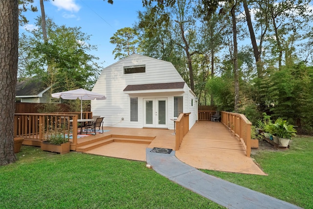 back of house with french doors, a yard, and a deck