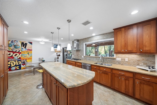 kitchen featuring sink, decorative light fixtures, stainless steel appliances, a center island, and light stone countertops