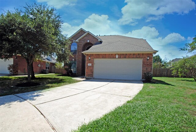 view of front of home featuring a garage and a front lawn