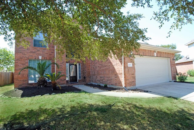 view of front facade with a front yard and a garage