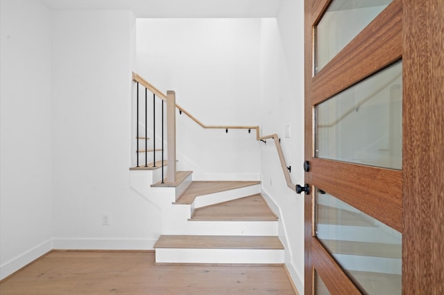 stairway featuring wood-type flooring