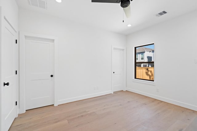 spare room featuring ceiling fan and light hardwood / wood-style flooring