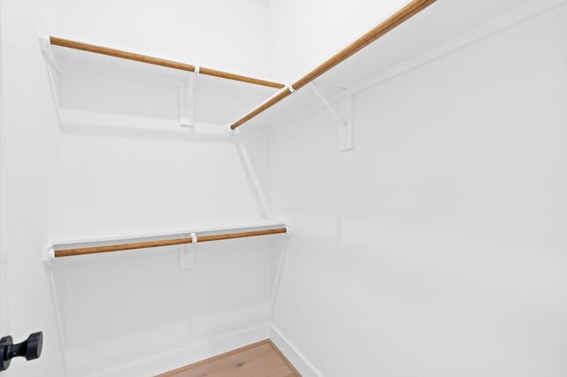 spacious closet featuring hardwood / wood-style floors