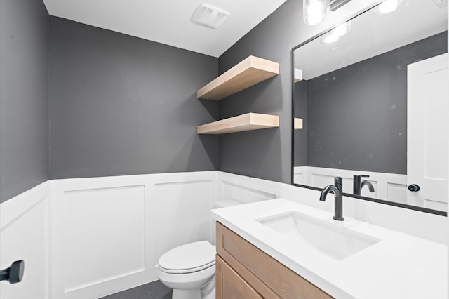 bathroom featuring toilet, tile patterned floors, and vanity