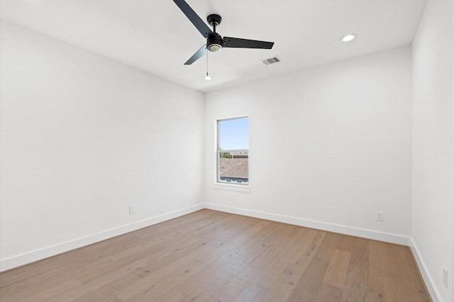 empty room with ceiling fan and light hardwood / wood-style floors