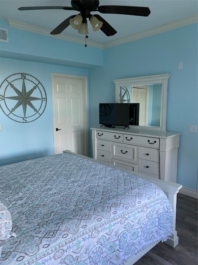 bedroom with dark wood-type flooring, ceiling fan, and crown molding