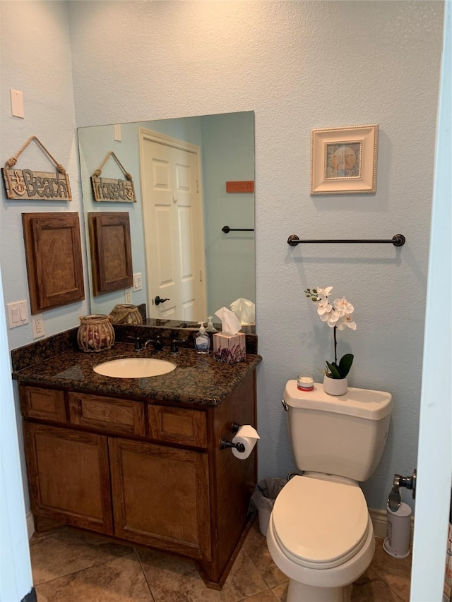 bathroom featuring toilet and vanity