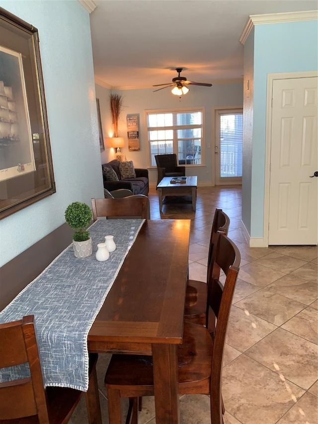 dining space featuring ceiling fan, tile patterned flooring, and crown molding