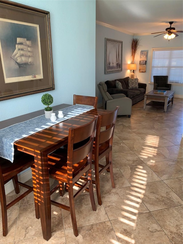 dining space featuring ceiling fan and crown molding