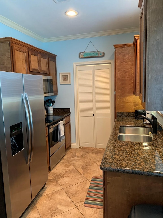 kitchen with sink, stainless steel appliances, dark stone counters, and ornamental molding