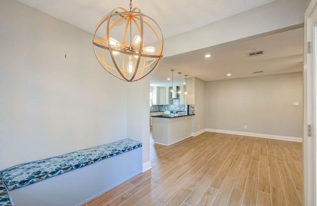 interior space with light wood-type flooring and a chandelier